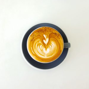 Latte with heart art, top view